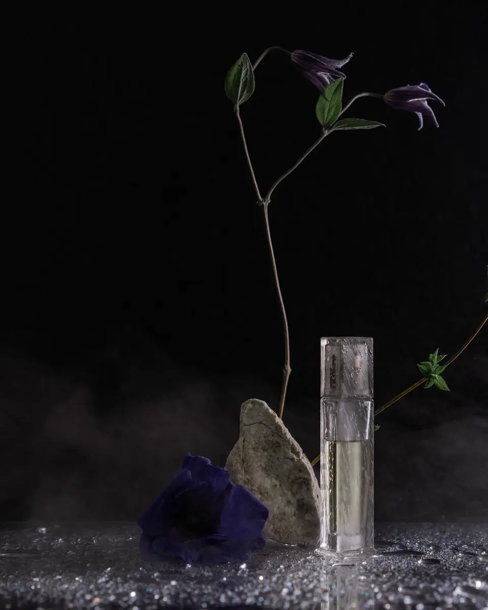 Fragrance bottles on a dark surface